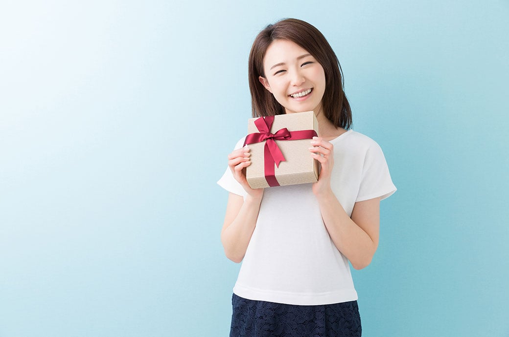 young attractive asian woman having a present